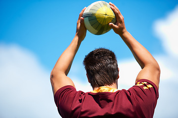 Image showing Rugby, sports and man throw ball outdoor on a pitch with blue sky for goal. Headshot of male athlete person playing in sport competition, game or training for fitness, workout or exercise from behind