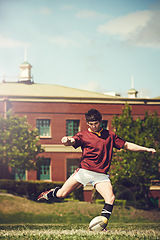 Image showing Rugby, sports and man kick a ball outdoor on a pitch with green lawn or grass. Male athlete person in action playing in sport competition, game or training match for fitness, workout or exercise