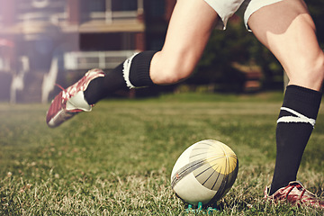 Image showing Rugby, man and feet kick sports ball outdoor on a pitch for action, goal or score. Male athlete person playing in sport competition, game or start training for fitness, workout or exercise on grass