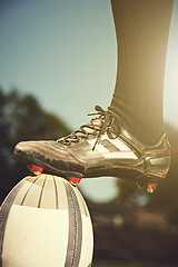 Image showing Rugby man, feet and sports ball outdoor on a pitch for action, goal or score. Male athlete closeup of shoes playing in sport competition, game or start training for fitness, workout or exercise