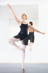 Image showing Ballerina, woman and ballet class with dancing, young dancer in rehearsal with art and grace at studio. Female person in pointe pose, balance and training for performance with creativity and fitness