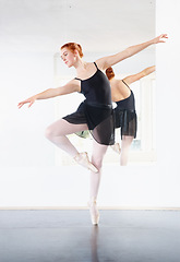 Image showing Ballerina, ballet and woman is dancing in class, young dancer in rehearsal with art and grace at studio. Female person in pointe pose, balance and training for performance with creativity and fitness