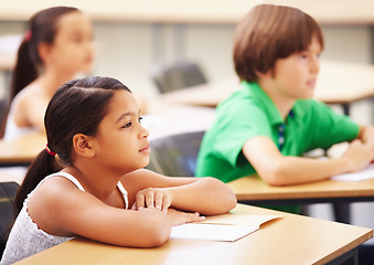 Image showing Education, students and girl in classroom with focus, attention and study at Montessori school. Children at desk studying with notebook, child development and kid with concentration in lesson or test