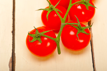 Image showing fresh cherry tomatoes on a cluster