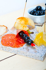 Image showing mix cold cut on a stone with fresh pears