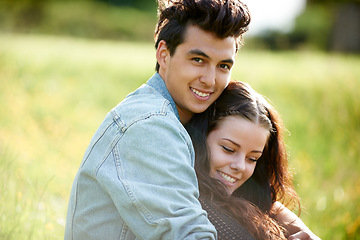 Image showing Field, love and couple relax in nature for romance, summer or valentines celebration with portrait, smile and sunshine. Young people or woman and partner on picnic, grass or countryside date together