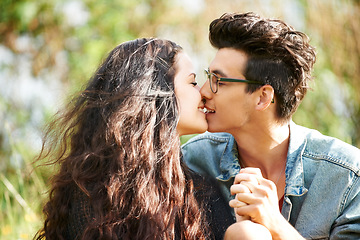 Image showing Park, love and couple kiss in nature for romance, summer and valentines celebration in outdoor sunshine. Young people or woman and partner relax in garden for countryside date together with smile