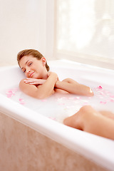 Image showing Woman portrait, rose and milk bath with flower petals and luxury bathroom treatment. Beauty body care, cleaning and female person relax in home with floral aromatherapy and natural wellness wash