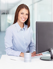 Image showing Portrait, smile and business woman typing on computer in office workplace. Keyboard, female entrepreneur and happy person or professional from Canada with pride for career, job or company occupation.