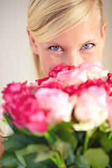 Image showing Roses, bouquet and portrait of woman in studio for valentines day, gift or thank you gesture on grey background. Face, rose and girl with flowers, happy and relax with floral arrangement on mockup