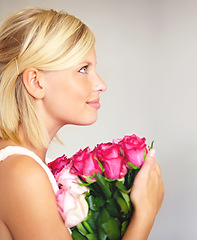 Image showing Woman, rose and bouquet in studio for valentines day, gift or thank you gesture on white background. Fresh, roses and girl with flowers, happy and relax with floral arrangement and mock up space