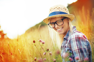 Image showing Lens flare, countryside and portrait of woman with flowers in field for freedom, wellness and fresh air outdoors. Nature, summer and happy female person in natural meadow for relaxing, calm and peace