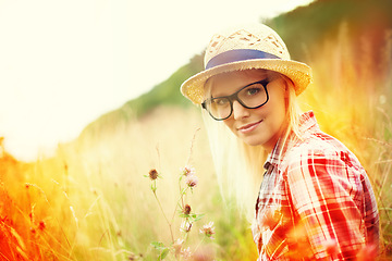 Image showing Field, countryside and portrait of woman with flowers for freedom, wellness and fresh air outdoors. Nature, summer and lens flare for female person in wild meadow for relaxing, calm and peace morning