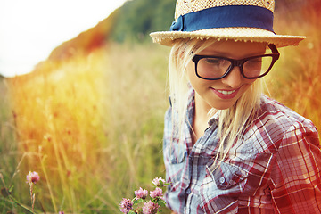 Image showing Lens flare, summer and woman with flowers in field for freedom, wellness and fresh air outdoors. Nature, countryside and happy female person in natural meadow for relaxing, calm and peace in morning