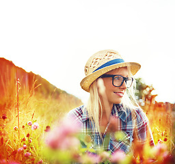 Image showing Lens flare, thinking and woman with flowers in field for freedom, wellness and contemplation outdoors. Countryside, summer and hipster female person in meadow for relaxing, calm and peace in morning