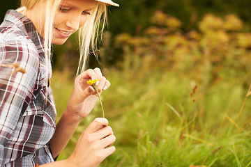 Image showing Spring, meadow and woman pick flower in field for freedom, wellness and fresh air outdoors. Nature, sunshine and happy hipster female person in countryside for relax, sustainability and ecology