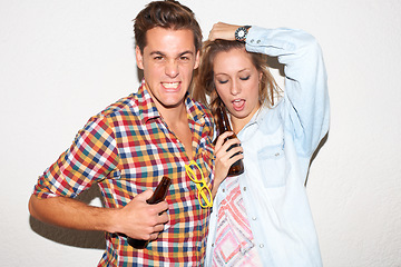 Image showing Portrait of gen z couple at party, beer and drunk face, hipster fashion with university youth culture. Drinks, woman and man in crazy picture at college event, happy friends on white wall background.