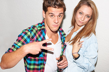 Image showing Portrait of couple at party, peace sign and beer, gen z fashion and university drinking culture in youth. Happiness, woman and man at fun college event with drinks and smile on white wall background.