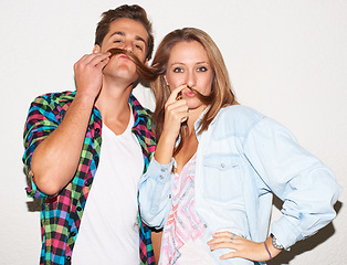 Image showing Funny portrait of cool couple with goofy face, gen z fashion and university culture with crazy hipster youth. Happiness, woman and man with fun at college, hair moustache on white wall background.