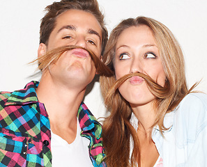 Image showing Playful, portrait and couple with hair mustaches being funny, comic and quirky together in a studio. Crazy, young and a man and woman being silly and goofy on a date isolated on a white background