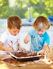 Image showing Baking, kids and messy friends in the kitchen together, having fun with ingredients while cooking. Children, food and bake with naughty young brother siblings making a mess on a counter in their home