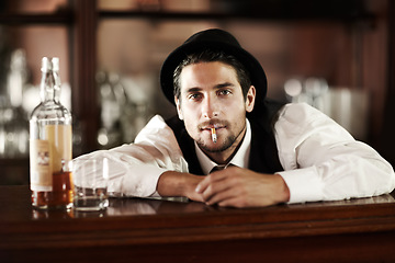 Image showing Bartender man, portrait and smoke cigarette at party, club or event with bottle for drink service. Male server, barman or waiter with glass, alcohol or whiskey to relax after work at restaurant job