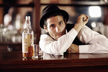 Image showing Bartender man, portrait and bottle with smoking, service, drink at party, club or event. Male server, barman or waiter with glass for alcohol, spirit or whiskey to relax after work at restaurant