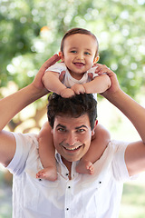 Image showing Park portrait, happiness and father with baby for toddler love, happy family parents and enjoy time together in nature. Youth kid, bond or infant with backyard dad, papa or man smile for child care