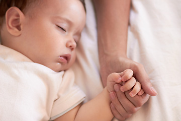 Image showing Baby, sleeping and mother holding hands in a home bedroom with parent support, care and love. Relax, bed and young girl with mom in a house tired and sleepy with kid and mama together feeling calm