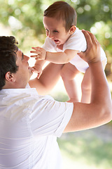 Image showing Nature, happy and father playing with baby for care, outdoor games and enjoy fun bonding time together in family park. Child growth, fatherhood and infant with playful dad, papa or man smile for kid