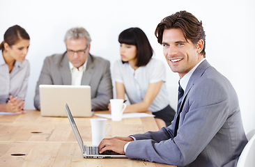 Image showing Business man in portrait, typing on laptop in meeting and corporate leader in conference room. Leadership, male person with smile and planning with technology in workplace, confidence and pride