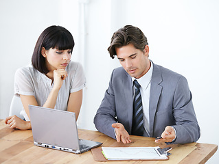 Image showing Business people, laptop and meeting for financial report, profit or discussing graph, data or chat at office desk. Businessman or woman in finance strategy, planning or investment review at workplace