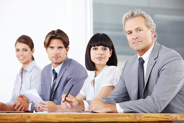 Image showing Portrait, collaboration and a group of business people sitting in the boardroom for a training meeting. Teamwork, strategy or planning with corporate men and women working together in the office