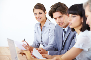 Image showing Business people, laptop and meeting with paperwork in strategy, marketing or collaboration at the office. Group of employees working together on computer in teamwork or brainstorming at the workplace