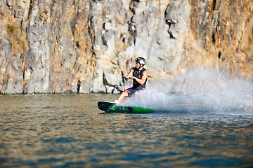 Image showing Splash, wakeboarding and water board with man in lake for extreme sports, summer break and travel vacation. Wave, adrenaline junkie and fitness with guy on river for health, adventure and training