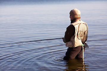 Image showing Nature, peace and fishing with man in lake for summer break, hobby and relax on vacation. Sports, casting and gear with fisherman standing in freshwater pond for holiday, recreation and calm