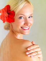 Image showing Flower, shower and portrait of woman in bathroom of hotel for cleaning, wellness or hygiene on spa vacation. Tropical, water and washing with girl in villa resort for beauty, skincare or hospitality