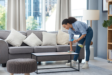 Image showing Spray, woman and cleaning table, furniture and housekeeping maintenance in living room. Happy female cleaner wipe surface with cloth, detergent and chemical bottle for dust, bacteria and disinfection