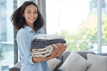 Image showing Portrait, laundry and cleaning with an african woman in her apartment holding fresh towels during housework. Smile, fabric and washing with a happy young female cleaner in the living room of her home