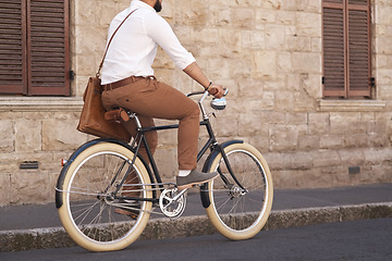 Image showing Businessman, eco friendly and riding bicycle to work or corporate guy or commuter on urban street and in the morning. Traveling, male professional and carbon neutral bike to the office or transport