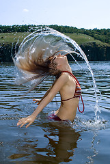 Image showing The beauty young woman bathes in the river