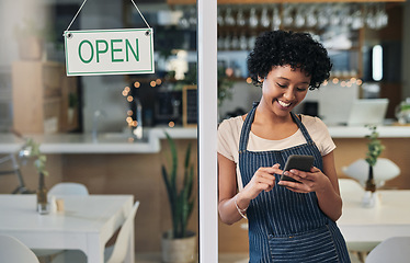 Image showing Happy woman, waitress and phone with open sign in communication, social media or online post at cafe. Female person, barista or manager with smile for opening store on smartphone at coffee shop