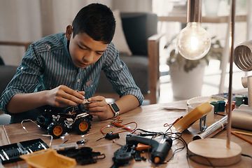 Image showing Learning, car robot and kid in home with homework, homeschool and science for tech project. Robotics, building and boy child with electrical knowledge, engineering education and studying in house.