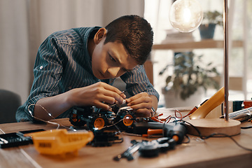 Image showing Education, car robot and kid in home with homework, homeschool and science, learning and tech project. Robotics, building and boy child with electrical knowledge, engineering and studying in house.