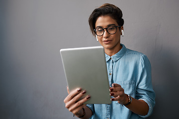 Image showing Tablet, music and young woman or student isolated on gray background for university e learning and online streaming. Creative gen z person on digital technology listening to audio on electronics app