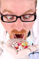 Image showing doctor taking hand full of tablets 