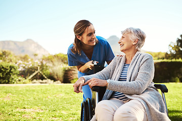 Image showing Senior woman, nurse and wheelchair for healthcare support, life insurance or garden at nursing home. Happy elderly female and caregiver helping patient or person with a disability in nature outdoors