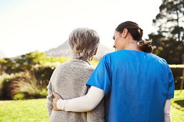 Image showing Senior woman, nurse and hug in elderly care, life insurance or support together in nature. Rear view of mature female with caregiver in healthcare, medical aid or garden walk at nursing home outdoors