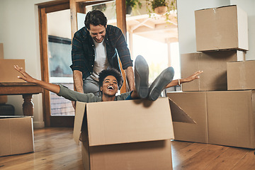 Image showing Happy couple, box and real estate moving in house or property in renovation or investment together. Interracial man and woman playing in living room with boxes for relocation, celebration or new home