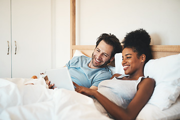 Image showing Happy couple, tablet and relax on bed for morning entertainment or online streaming together at home. Interracial man and woman person relaxing in bedroom on technology for social media or browsing